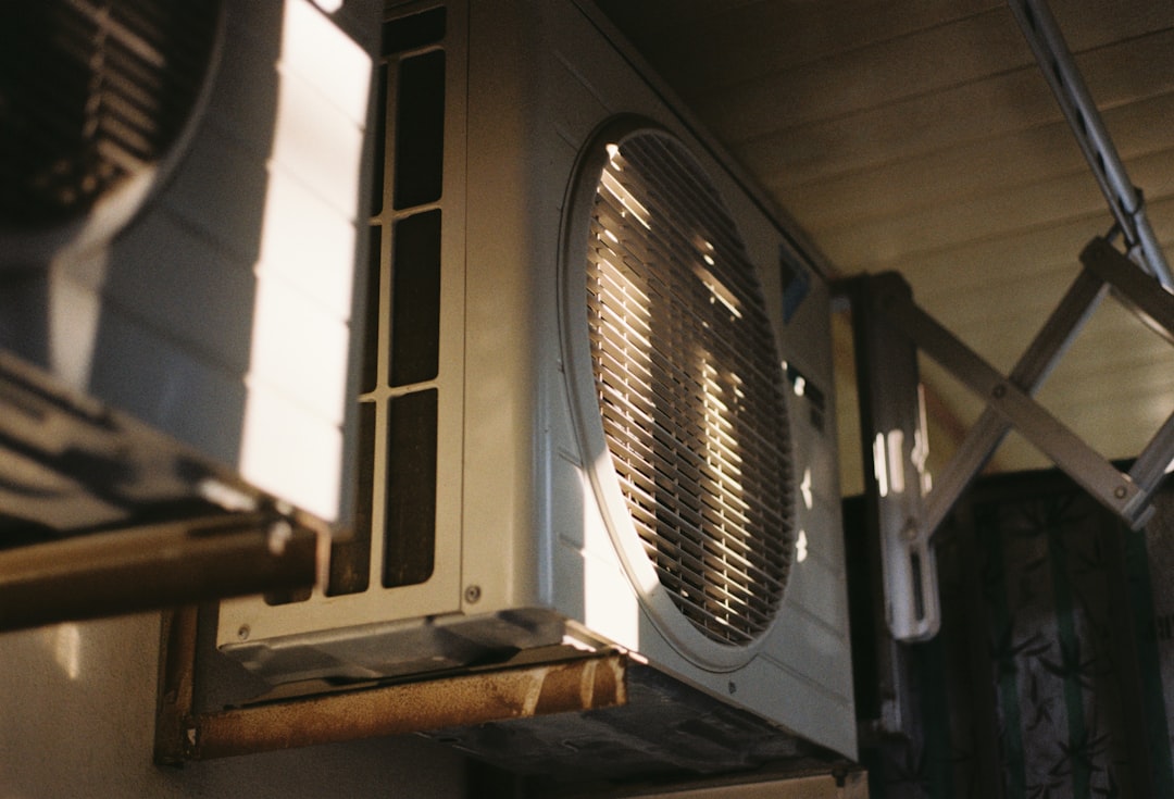 Close-up of an outdoor air conditioning unit on a sunny day representing HVAC business automation