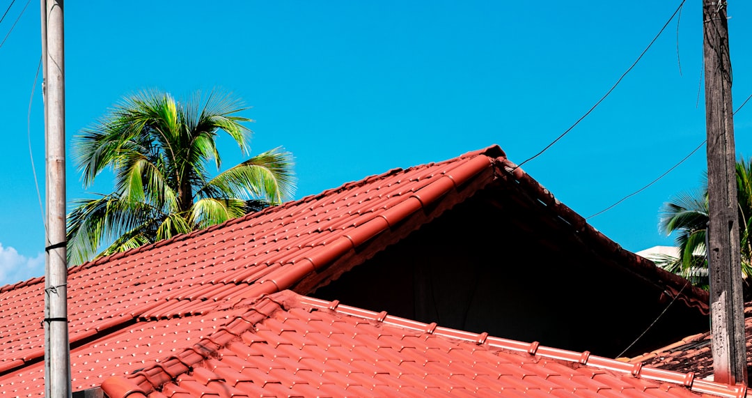 Red tiled roof against bright blue sky representing roofing contractor local SEO keyword strategy