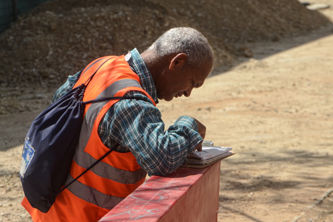 Contractor reviewing paperwork on job site