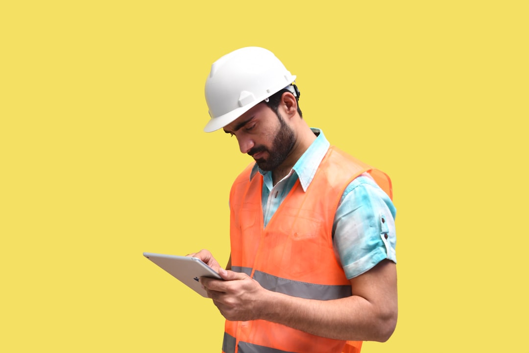 Contractor using a mobile app to schedule crew assignments on a job site