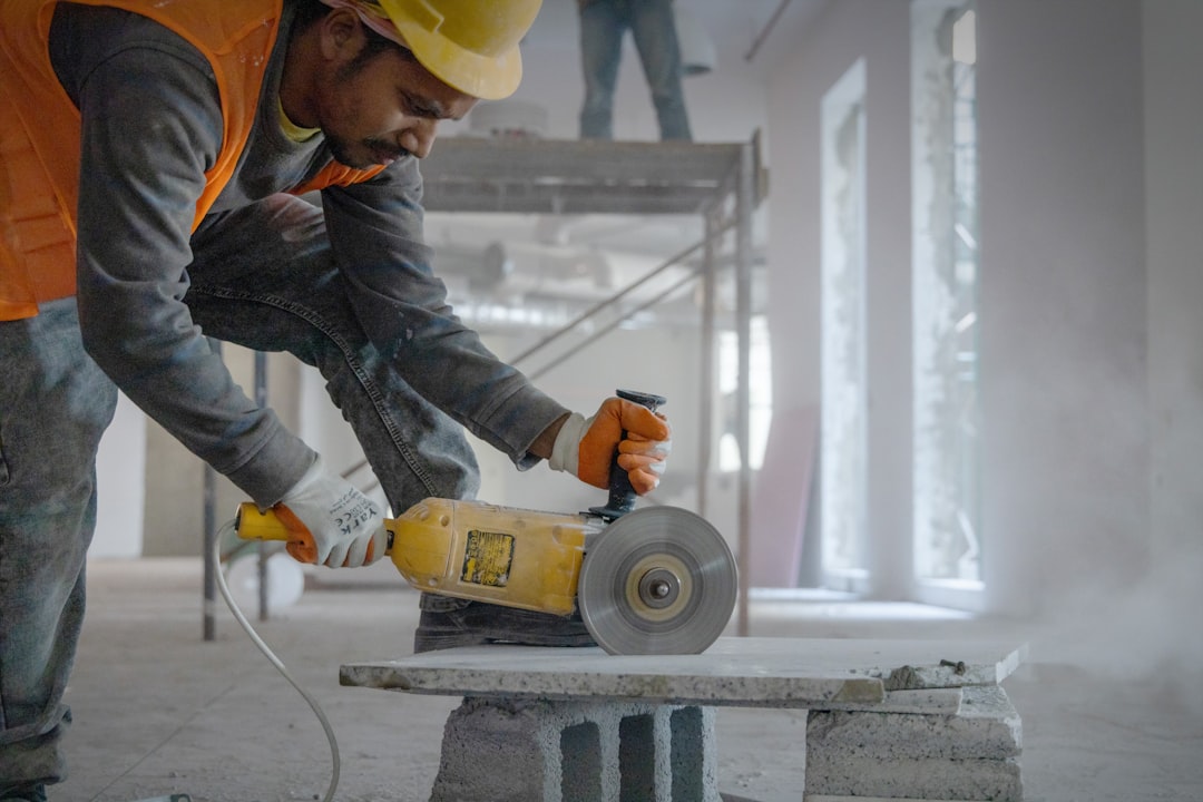 Civil engineer and construction workers on an active job site wearing safety helmets and vests